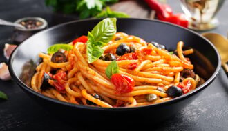 Spaghetti alla puttanesca - italian pasta dish with tomatoes