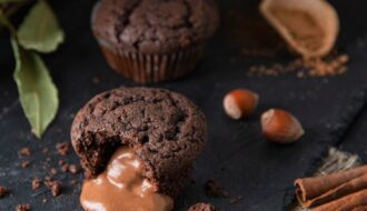 baked hot chocolate fondant with hazelnut, cinnamon and leaked filling on black shale background