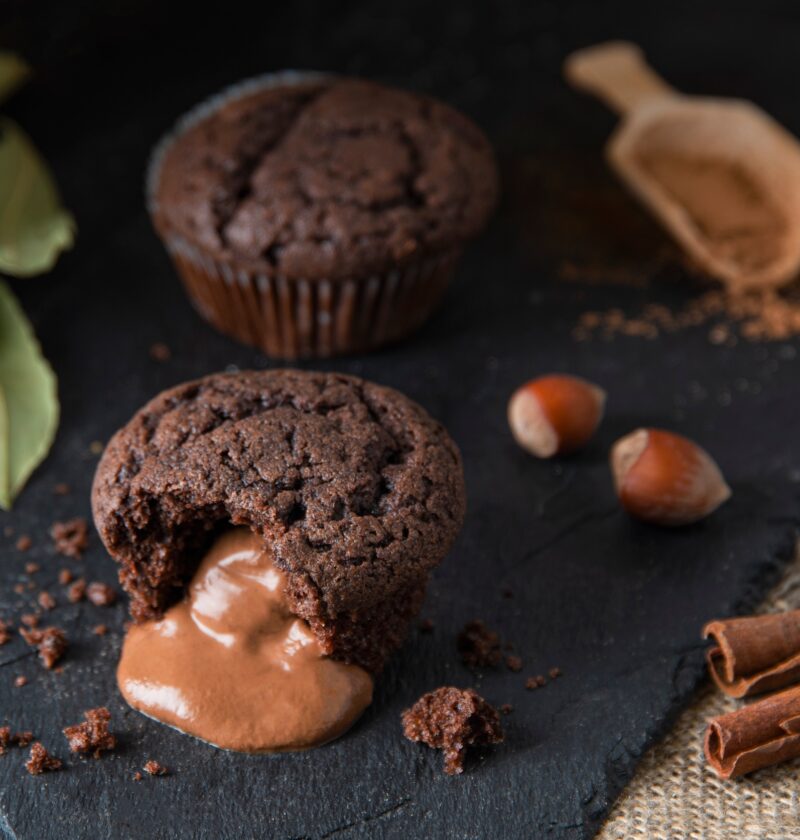 baked hot chocolate fondant with hazelnut, cinnamon and leaked filling on black shale background