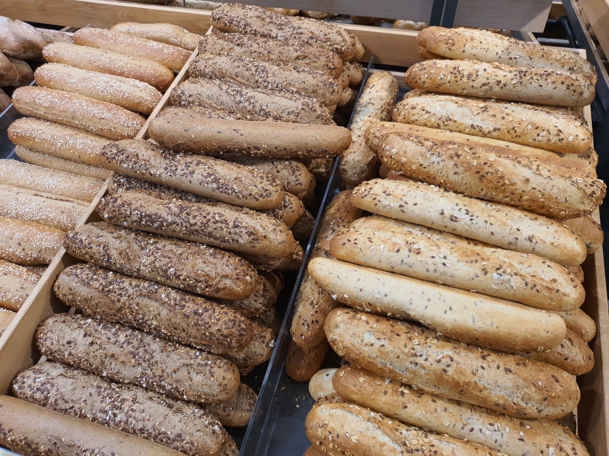 Different types of French baguettes in a bakery