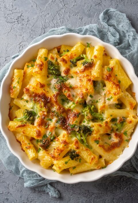 Pasta baked with broccoli and chicken. Broccoli, cheese and gratin sauce on baked penne pasta.