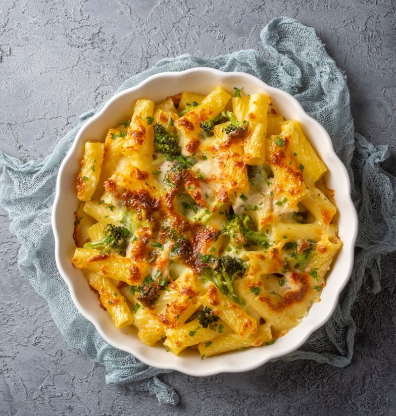 Pasta baked with broccoli and chicken. Broccoli, cheese and gratin sauce on baked penne pasta.