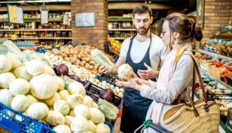 Shop worker with woman in the supermarket