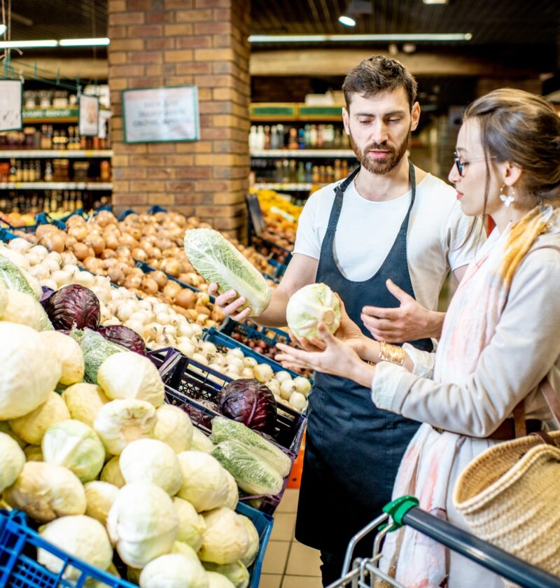 Shop worker with woman in the supermarket