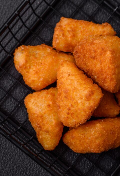 Breaded camembert or brie cheese baked in the form of nuggets with salt and spices