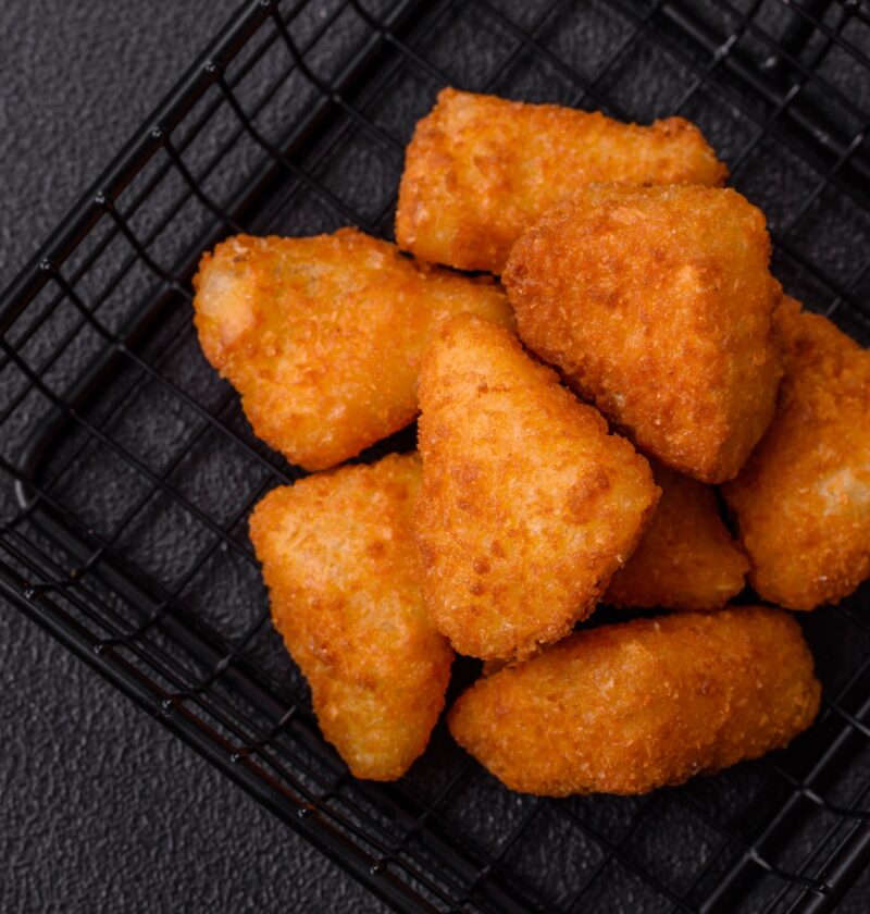 Breaded camembert or brie cheese baked in the form of nuggets with salt and spices