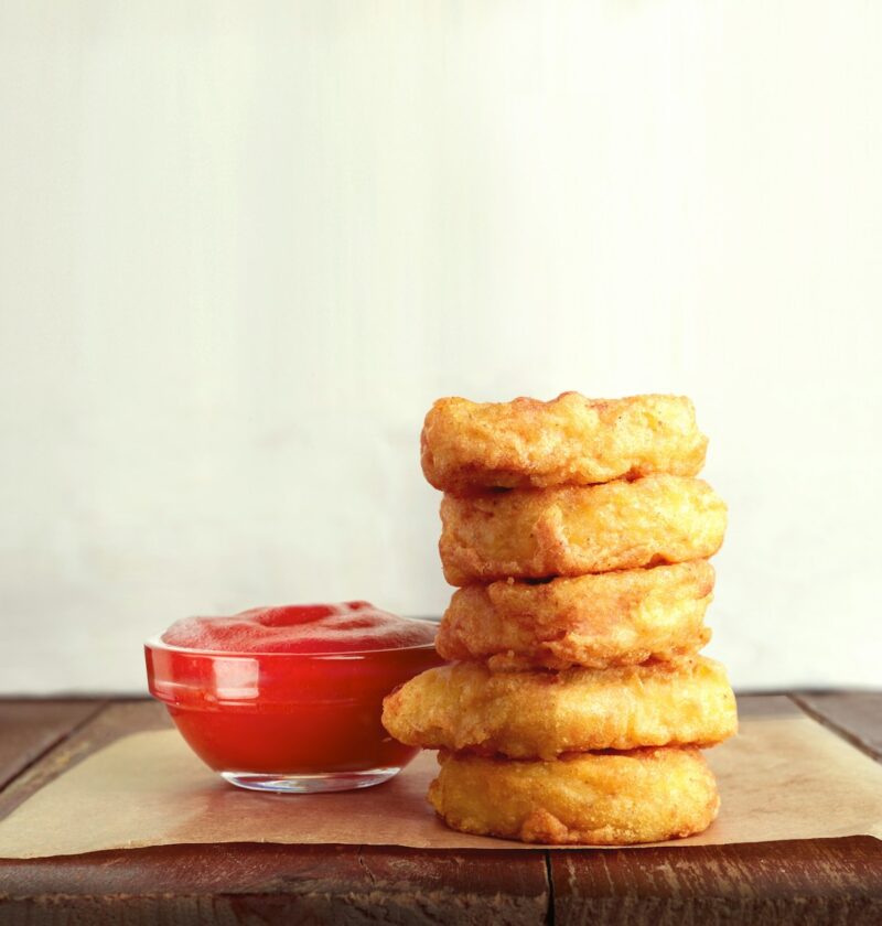 three cookies on brown wooden chopping board